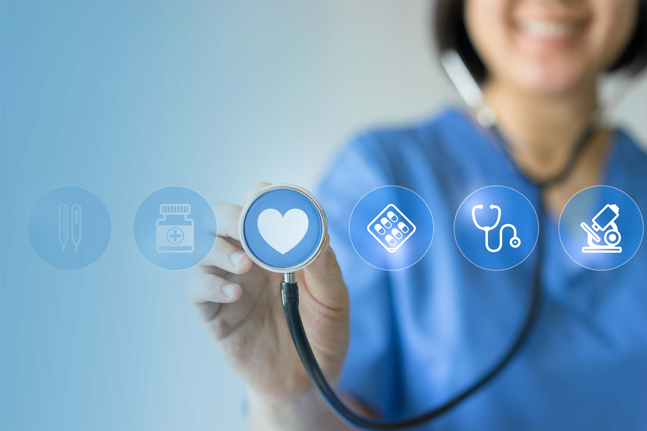 Healthcare provider holding up stethoscope with heart icon